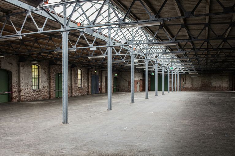 Gewerbliche Entrümpelung – leere Industriehalle mit Stahlträgern und Backsteinwänden nach einer professionellen Räumung

